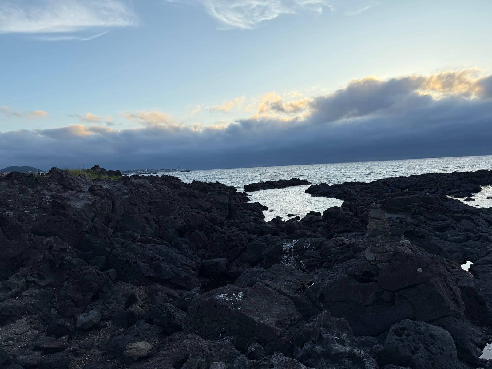 Volcanic rock coastline at sunset